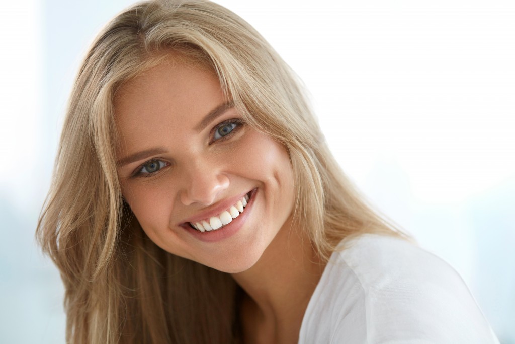 Woman Smiling with Her Teeth Showing