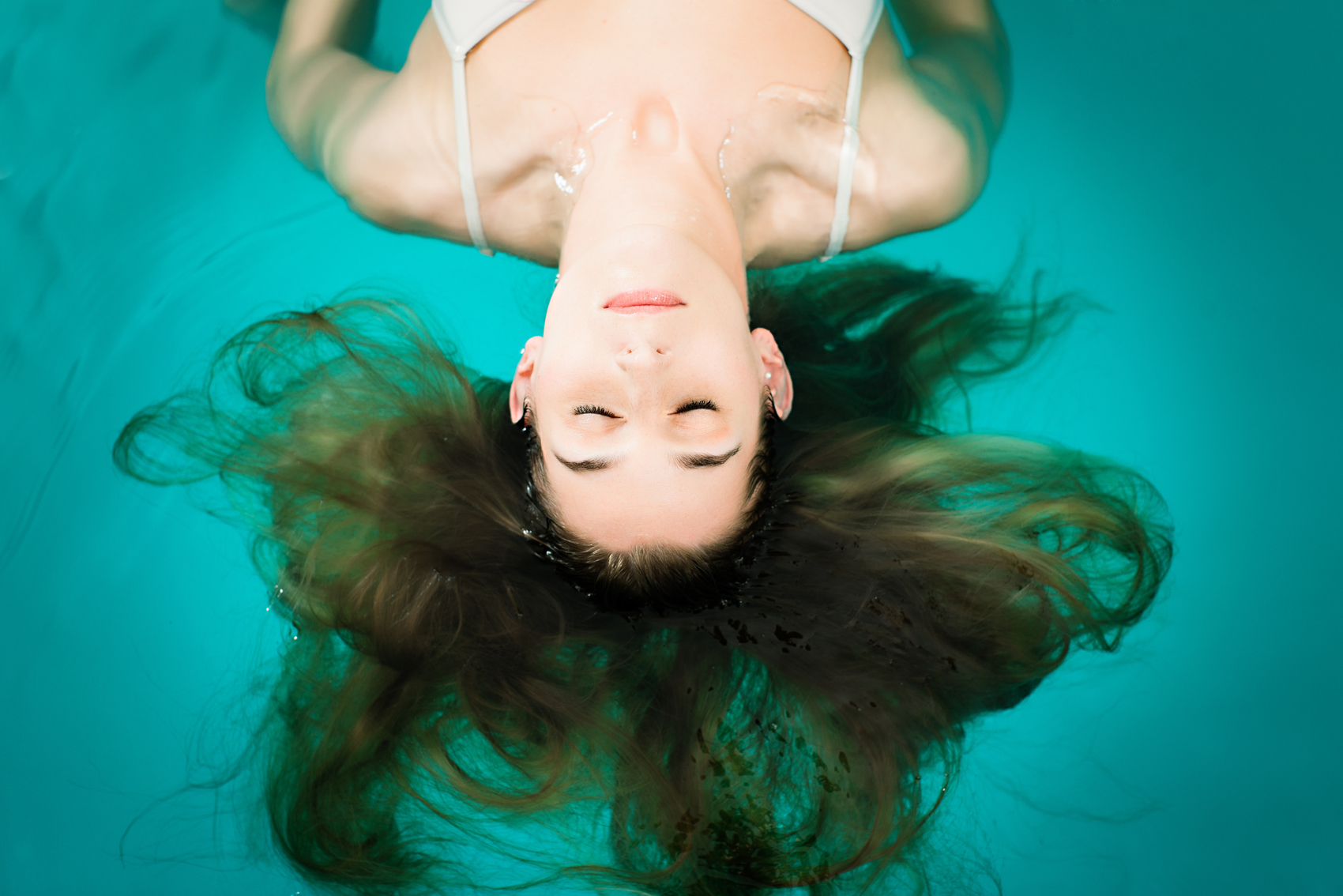 Woman Floating in a Pool
