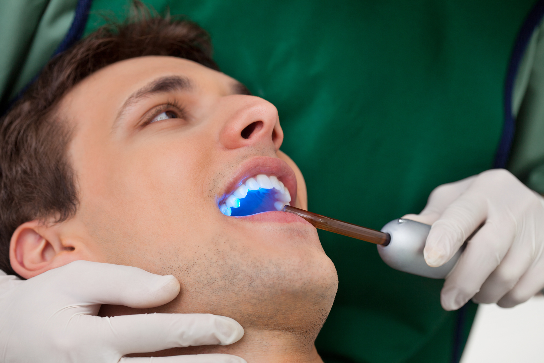 Man getting a checkup with a cosmetic dentist