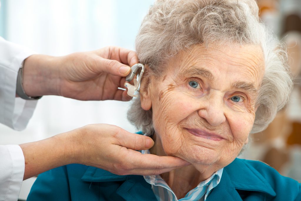 Old Woman Being Fitted With Hearing Aid