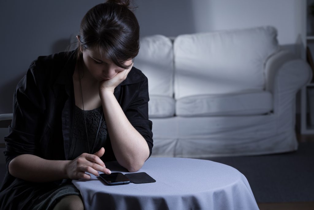 Lonely woman after divorce spending evening alone