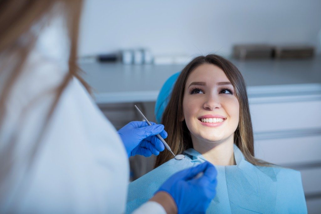 Female patient speaking to dentist