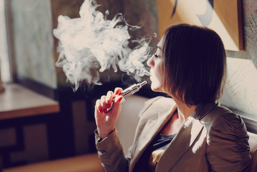 woman using electronic cigarette