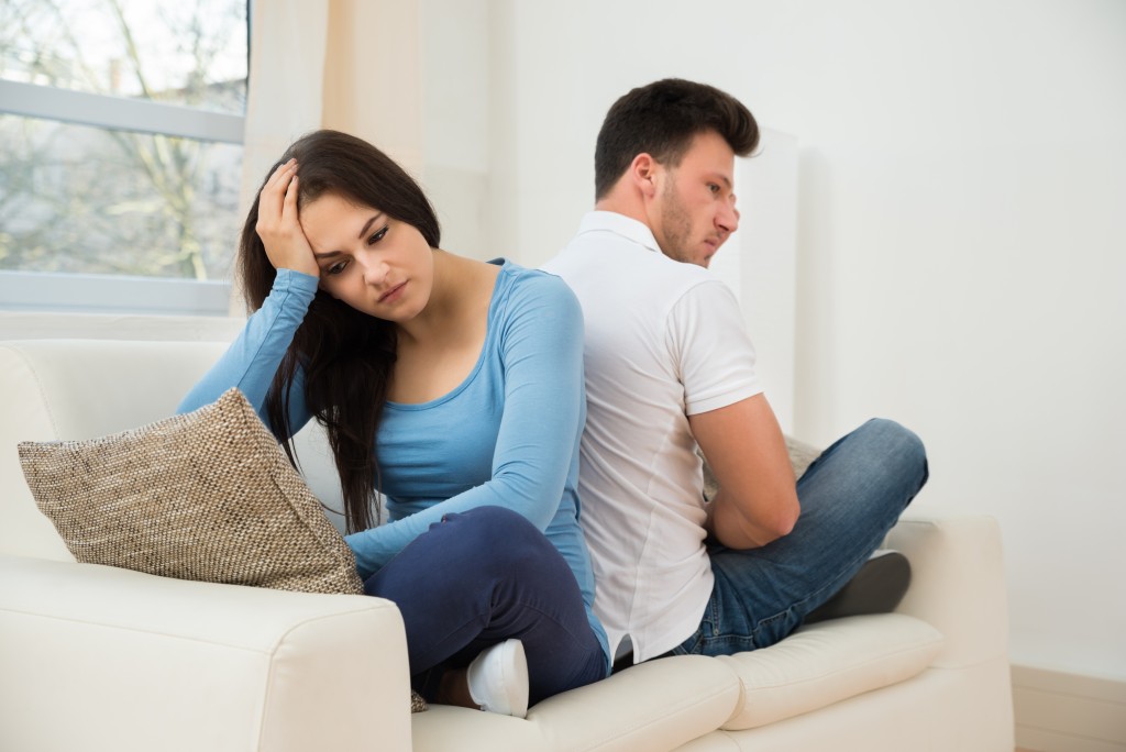 Frustrated couple sitting back-to-back