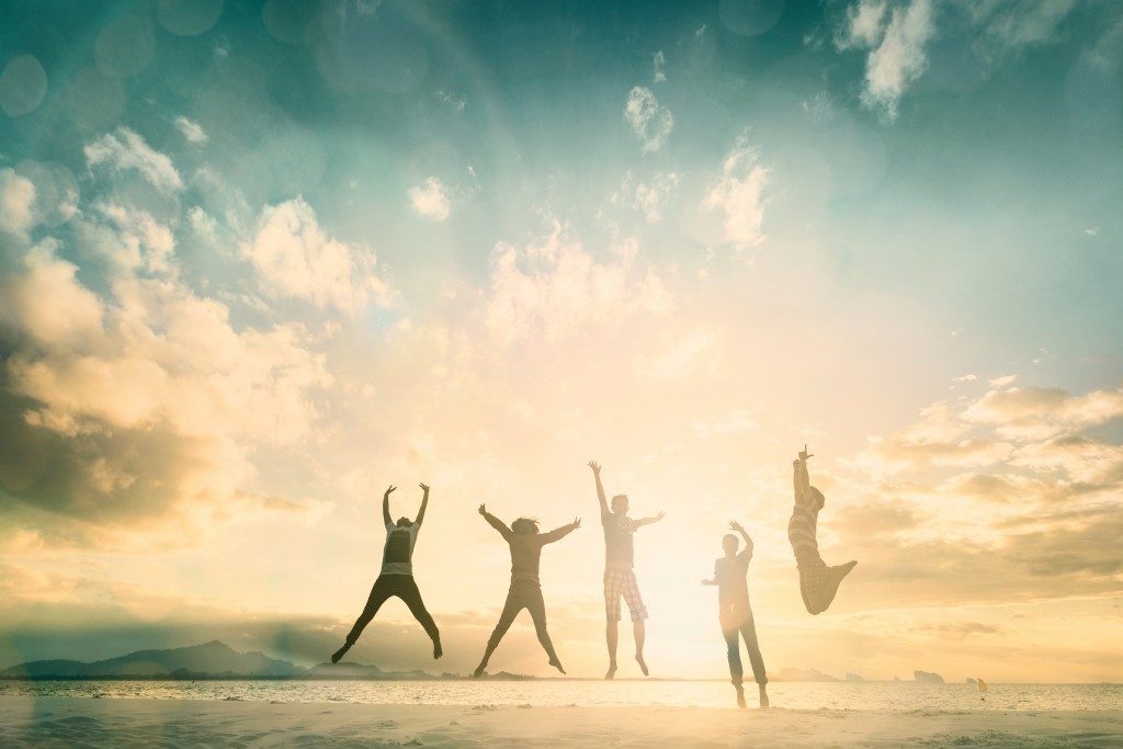 Teens jumping with sunrise background