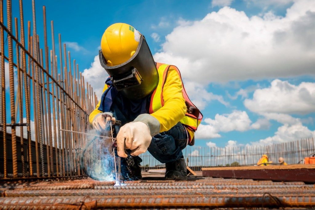 Construction worker welding at the site