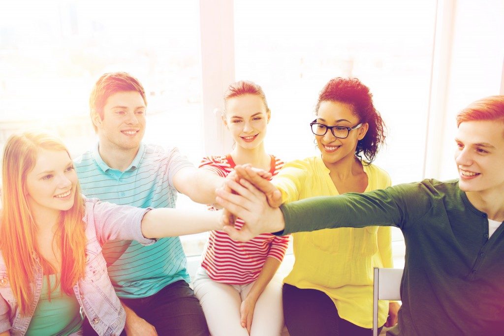 Group of teenagers holding hands