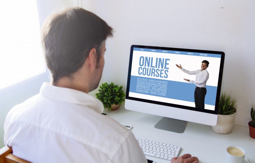 man checking online course software