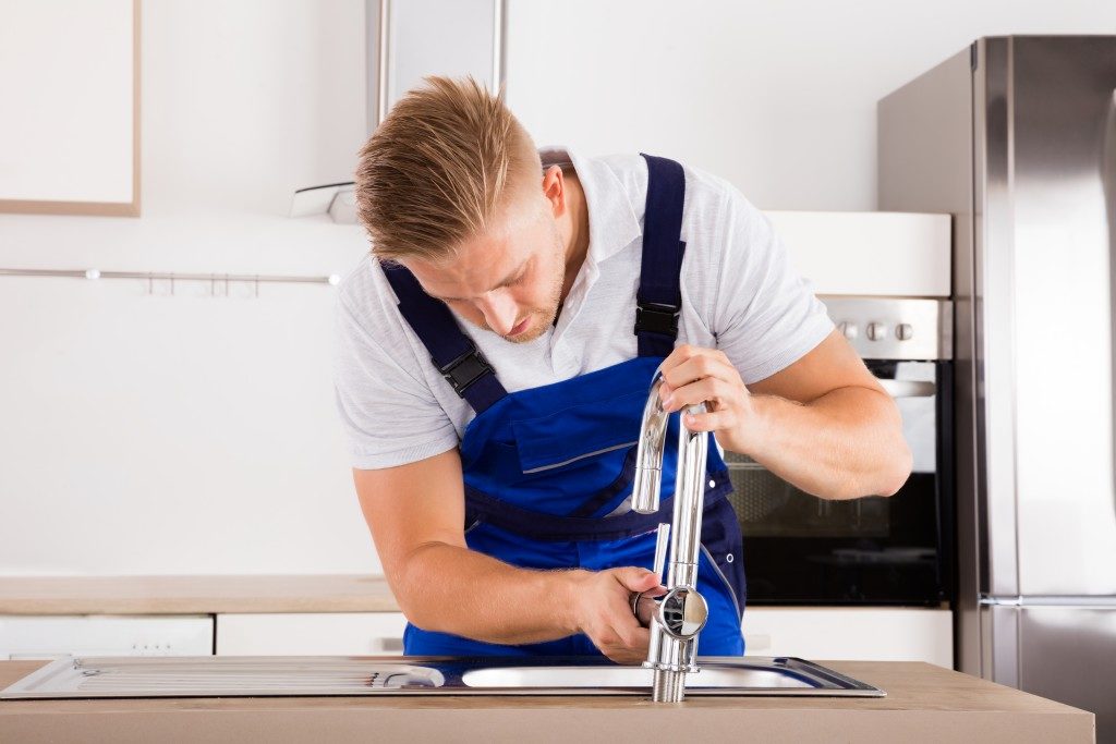 plumber fixing faucet