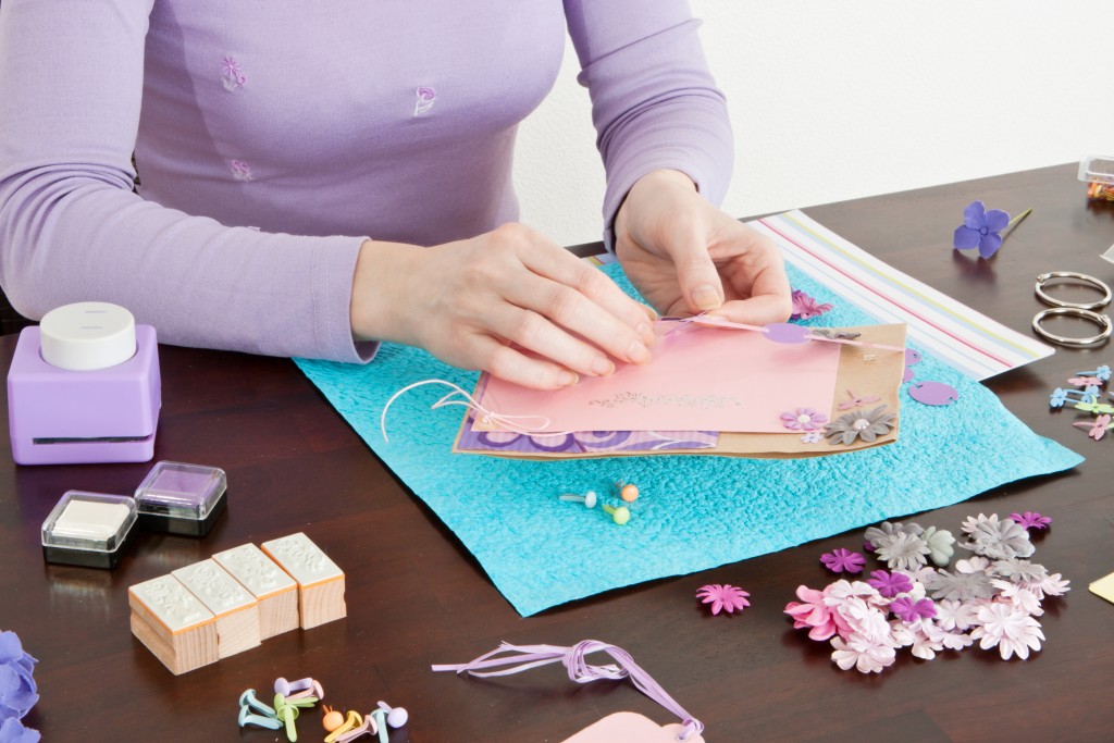 woman wrapping gifts and adding handcrafted designs