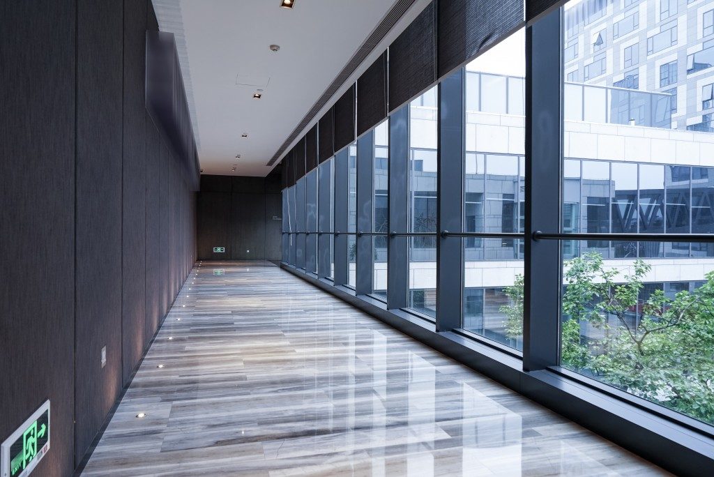 building hallway in tiles flooring and dark wood walls