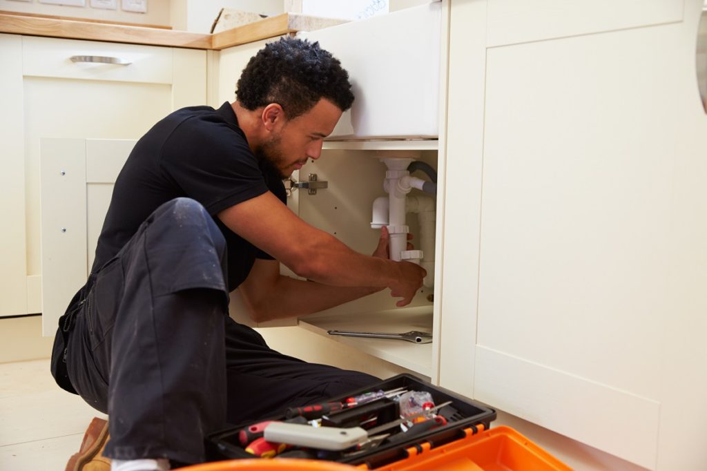 plumber fixing the sink