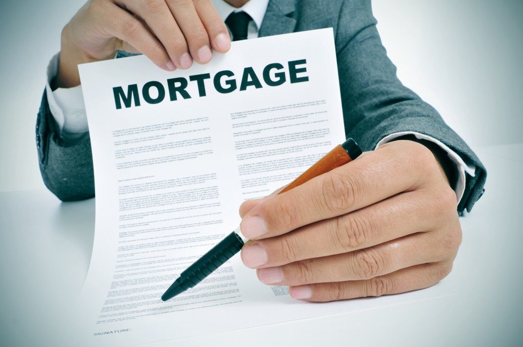 Businessman holding a mortgage contract