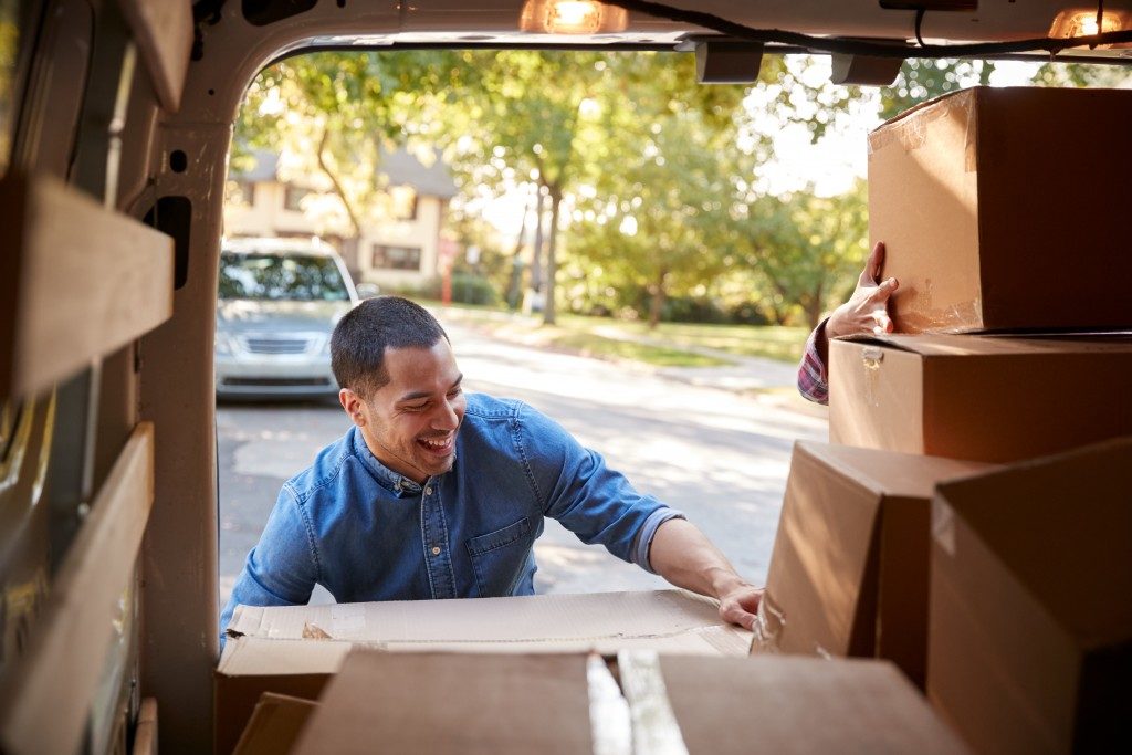 Man putting boxes inside a van