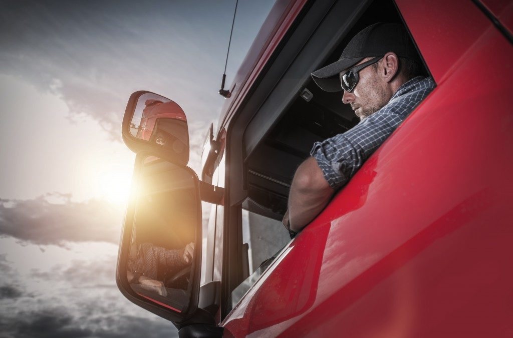 driver inside a red truck