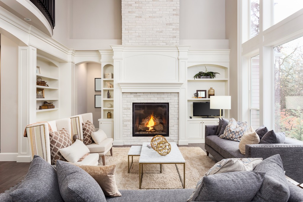 classy home with chairs and sofas around the fireplace