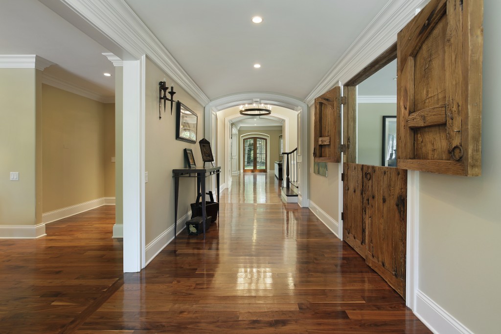 Long foyer with wooden barn doors into living room