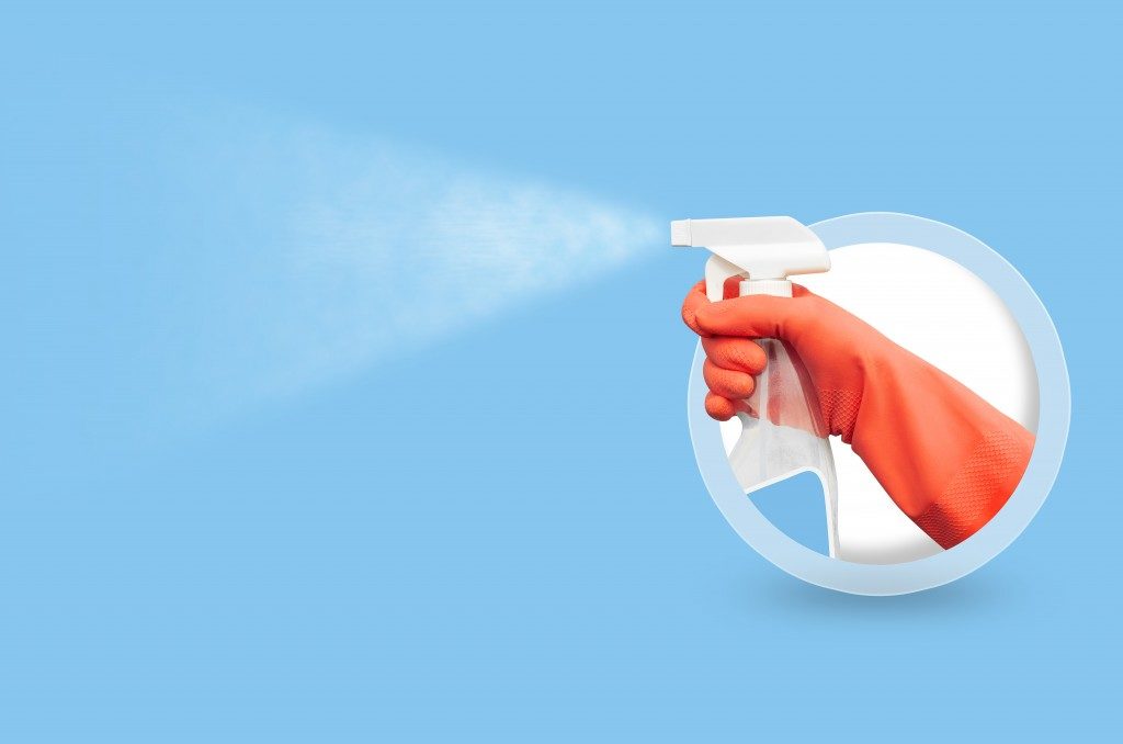 Spray bottle on blue background