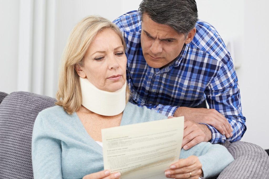 woman reading document after accident