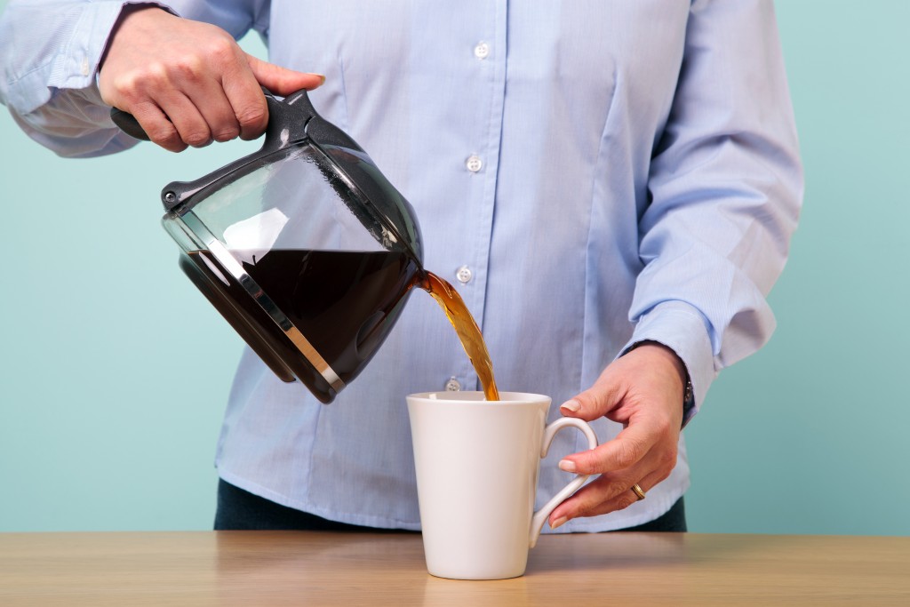 Pouring herself a coffee