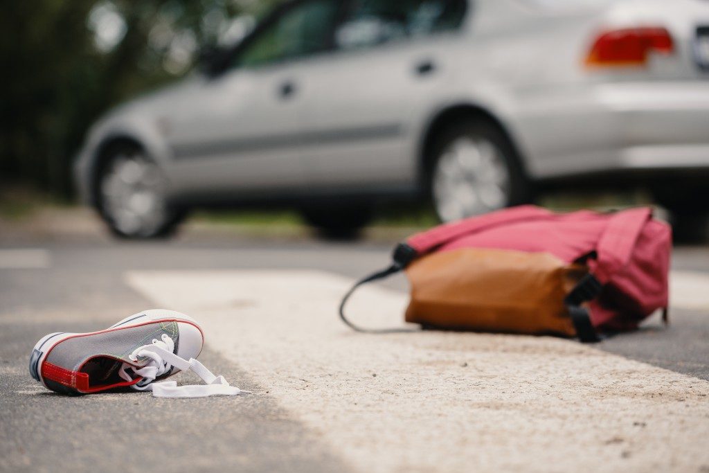 Shoe and bag in the foreground to signify car crash