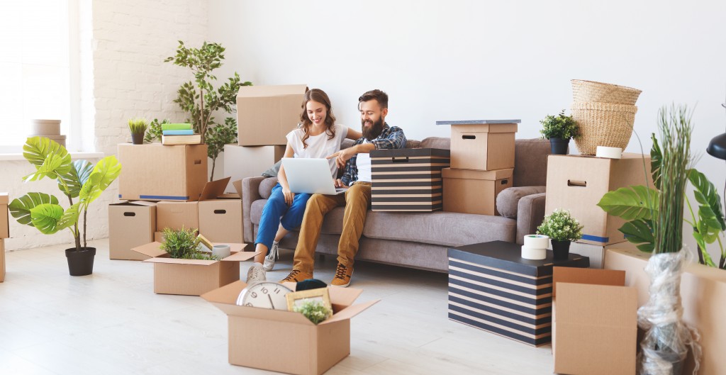 couple unpacking items into new home