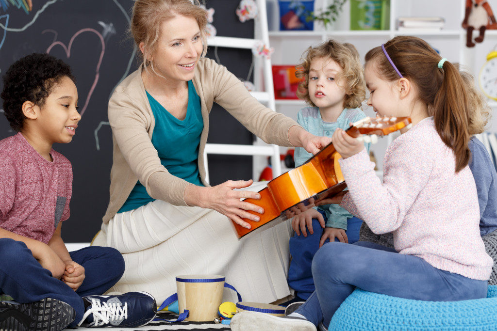 preschool students with their music teacher