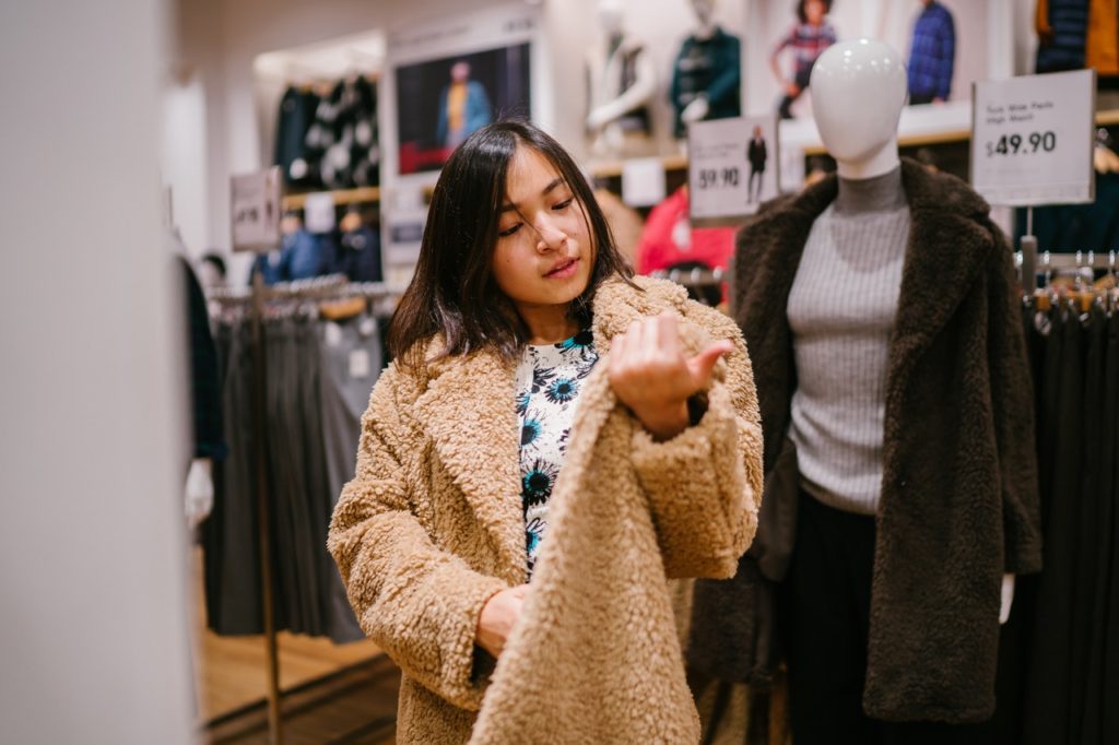 woman trying on a coat