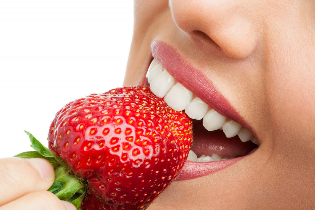 closeup biting strawberry