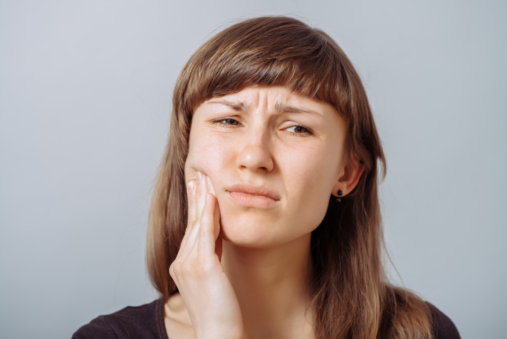 woman with toothache concept of dental problem