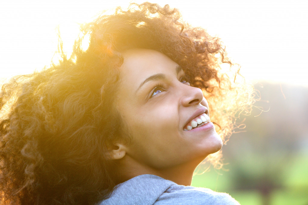 woman happily smiling looking up