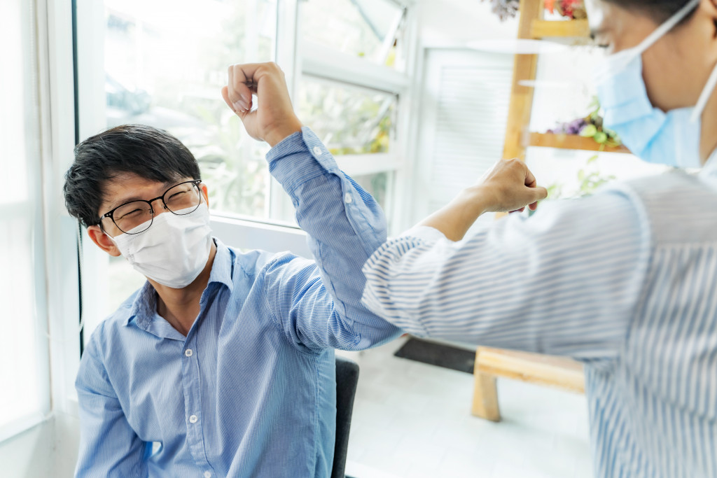 asian employee wearing face mask post-COVID